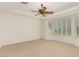 The main bedroom features plush carpeting and multiple windows covered in plantation shutters at 10463 Luna Magico Ave, Las Vegas, NV 89135