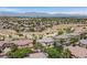 Wide community aerial view showing homes, landscaping, desert and mountain landscape in the distance at 10640 Amber Ridge Dr # 101, Las Vegas, NV 89144