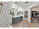 A bright bathroom features a double sink vanity, walk-in glass shower, and opens to a walk-in closet at 10640 Amber Ridge Dr # 101, Las Vegas, NV 89144