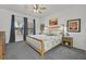 A cozy bedroom features a ceiling fan and a large window with shutter-style blinds at 10640 Amber Ridge Dr # 101, Las Vegas, NV 89144