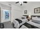 Bedroom featuring two beds, sliding closet, a ceiling fan, and warm lighting at 10640 Amber Ridge Dr # 101, Las Vegas, NV 89144