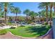 Resort-style community pool with lush landscaping, putting green, and seating areas at 10640 Amber Ridge Dr # 101, Las Vegas, NV 89144