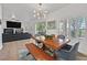 A cozy dining area features a wood table and bench, and it is open to the living room with fireplace at 10640 Amber Ridge Dr # 101, Las Vegas, NV 89144