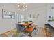 The dining room features a wooden table with seating, modern light fixture, and bar seating at the kitchen counter at 10640 Amber Ridge Dr # 101, Las Vegas, NV 89144