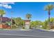 Grand gated entrance with lush landscaping and a welcoming guard house at 10640 Amber Ridge Dr # 101, Las Vegas, NV 89144