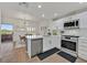 This bright kitchen features white cabinets, stainless appliances, and an open connection to the dining area at 10640 Amber Ridge Dr # 101, Las Vegas, NV 89144