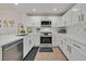 Well-lit kitchen featuring white cabinets, sleek countertops, and updated stainless steel appliances at 10640 Amber Ridge Dr # 101, Las Vegas, NV 89144