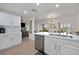 Modern kitchen features white cabinets, stainless steel appliances, and an adjacent dining area at 10640 Amber Ridge Dr # 101, Las Vegas, NV 89144