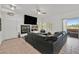 Open-concept living room features a fireplace, TV, and access to the outdoor patio at 10640 Amber Ridge Dr # 101, Las Vegas, NV 89144
