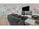 Large living room features a black leather sectional, TV, and plenty of space to relax and entertain at 10640 Amber Ridge Dr # 101, Las Vegas, NV 89144
