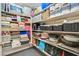 Pantry shelves provide abundant storage with neatly stacked towels, bins, and kitchenware at 10640 Amber Ridge Dr # 101, Las Vegas, NV 89144