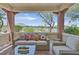 Covered patio features cozy seating and views of the surrounding mountain landscape at 10640 Amber Ridge Dr # 101, Las Vegas, NV 89144