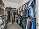 This walk-in closet features built-in organizers and plenty of hanging storage space at 10640 Amber Ridge Dr # 101, Las Vegas, NV 89144