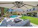 Spacious backyard with a fire pit, comfortable seating, swimming pool, and outdoor kitchen at 1404 Reisling Ct, Las Vegas, NV 89144