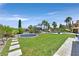Expansive backyard with lush lawn, trampoline, pool, and inviting outdoor lounge area at 1404 Reisling Ct, Las Vegas, NV 89144