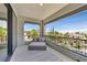 Spacious covered balcony with comfortable seating and a stunning view of lush landscaping at 1404 Reisling Ct, Las Vegas, NV 89144