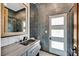 Modern bathroom features a sleek vanity, stylish tile, and a glass-enclosed shower at 1404 Reisling Ct, Las Vegas, NV 89144
