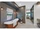 Elegant soaking tub in a bathroom with a view of a glass shower and access to the bedroom at 1404 Reisling Ct, Las Vegas, NV 89144