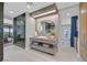 Stylish bathroom with an elegant vanity, large mirror, and a glass-enclosed shower at 1404 Reisling Ct, Las Vegas, NV 89144