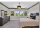 Relaxing bedroom with neutral tones, complemented by tree-themed wall art and a dark wood dresser at 1404 Reisling Ct, Las Vegas, NV 89144
