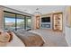 Relaxing bedroom with a fireplace, TV, and a balcony providing an inviting space for relaxation at 1404 Reisling Ct, Las Vegas, NV 89144