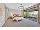 Spacious main bedroom with a cozy king bed, balcony access, and elegant decor at 1404 Reisling Ct, Las Vegas, NV 89144