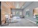 Tranquil bedroom with wood slat accent wall, soft lighting, neutral palette, and comfortable seating area at 1404 Reisling Ct, Las Vegas, NV 89144