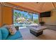 Relaxing cabana with comfortable seating, fire table, TV, overlooking the pool and waterfall at 1404 Reisling Ct, Las Vegas, NV 89144