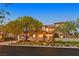 Beautiful home featuring manicured landscaping and inviting curb appeal with mature trees at 1404 Reisling Ct, Las Vegas, NV 89144
