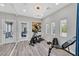 Bright home gym with exercise equipment, mirrored wall and glass doors to covered patio at 1404 Reisling Ct, Las Vegas, NV 89144