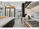Modern kitchen featuring stainless steel appliances, quartz countertops, dark cabinetry, and a convenient wine rack at 1404 Reisling Ct, Las Vegas, NV 89144