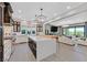 Gourmet kitchen with a large island, stainless steel appliances, and open access to the living area at 1404 Reisling Ct, Las Vegas, NV 89144