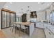 Well-appointed kitchen features a large island with seating, custom cabinets, and modern appliances at 1404 Reisling Ct, Las Vegas, NV 89144