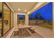 Covered outdoor patio with dining area and bar seating overlooking the well manicured lawn at 1404 Reisling Ct, Las Vegas, NV 89144