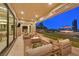 Inviting outdoor patio featuring comfortable seating, a fire pit, and views of the beautifully landscaped backyard at 1404 Reisling Ct, Las Vegas, NV 89144