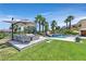Beautiful pool area featuring a waterfall, lush landscaping, and comfortable outdoor seating at 1404 Reisling Ct, Las Vegas, NV 89144
