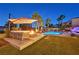 Amazing backyard featuring a pool with a waterfall feature, outdoor seating, and lush landscaping at 1404 Reisling Ct, Las Vegas, NV 89144