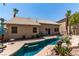 The home has an in-ground pool and spa, and a mature backyard with palm trees and other shade trees at 1761 Summerwood Cir, Henderson, NV 89012
