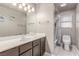 The bathroom features a large mirror and vanity, a shower-tub combo, and great lighting at 1761 Summerwood Cir, Henderson, NV 89012
