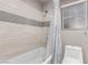The tub and shower have custom tiling with decorative touches in this secondary bathroom at 1761 Summerwood Cir, Henderson, NV 89012