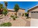 Landscaped front yard with desert flora, a paved walkway, and a gated side entrance at 1761 Summerwood Cir, Henderson, NV 89012