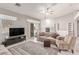 Bright living room with neutral colors, a cozy sectional, and access to the outdoor patio at 1761 Summerwood Cir, Henderson, NV 89012