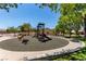 Community playground with swings, slides, and spring riders, set amongst mature trees, perfect for Gathering fun at 1761 Summerwood Cir, Henderson, NV 89012