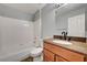 Bathroom with granite vanity top and white tiled shower and tub combo at 198 Winterport St, Henderson, NV 89074