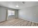 This bedroom features wood floors, a window with curtains, and neutral-painted walls at 198 Winterport St, Henderson, NV 89074