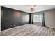 Bedroom with stylish flooring, dark accent wall, and a window at 198 Winterport St, Henderson, NV 89074