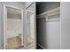 Walk-in closet leading to the bathroom with mirrors and closet rod at 198 Winterport St, Henderson, NV 89074