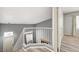 Upstairs entry hallway with white railing and wood-style vinyl flooring at 198 Winterport St, Henderson, NV 89074