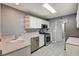 Efficient kitchen featuring white cabinets, stainless steel appliances, and tile flooring at 198 Winterport St, Henderson, NV 89074