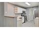 Well-lit kitchen with stainless steel appliances, open shelving, and tile flooring at 198 Winterport St, Henderson, NV 89074